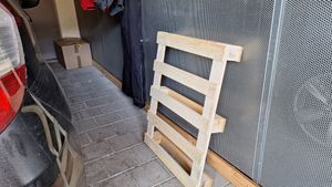 Photo of a Euro pallet in my garage. It is leaning against the side, narrowing the passageway beside my car.
